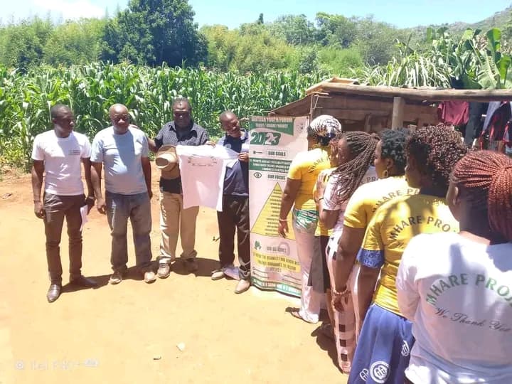 Mhare Project team showcasing the 2023 community banner